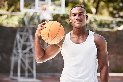 Buy stock photo Portrait of a young black male basketball player holding a ball, playing a match on a local sports court outside. One cool muscular man with attitude taking a break to play a fun recreational game