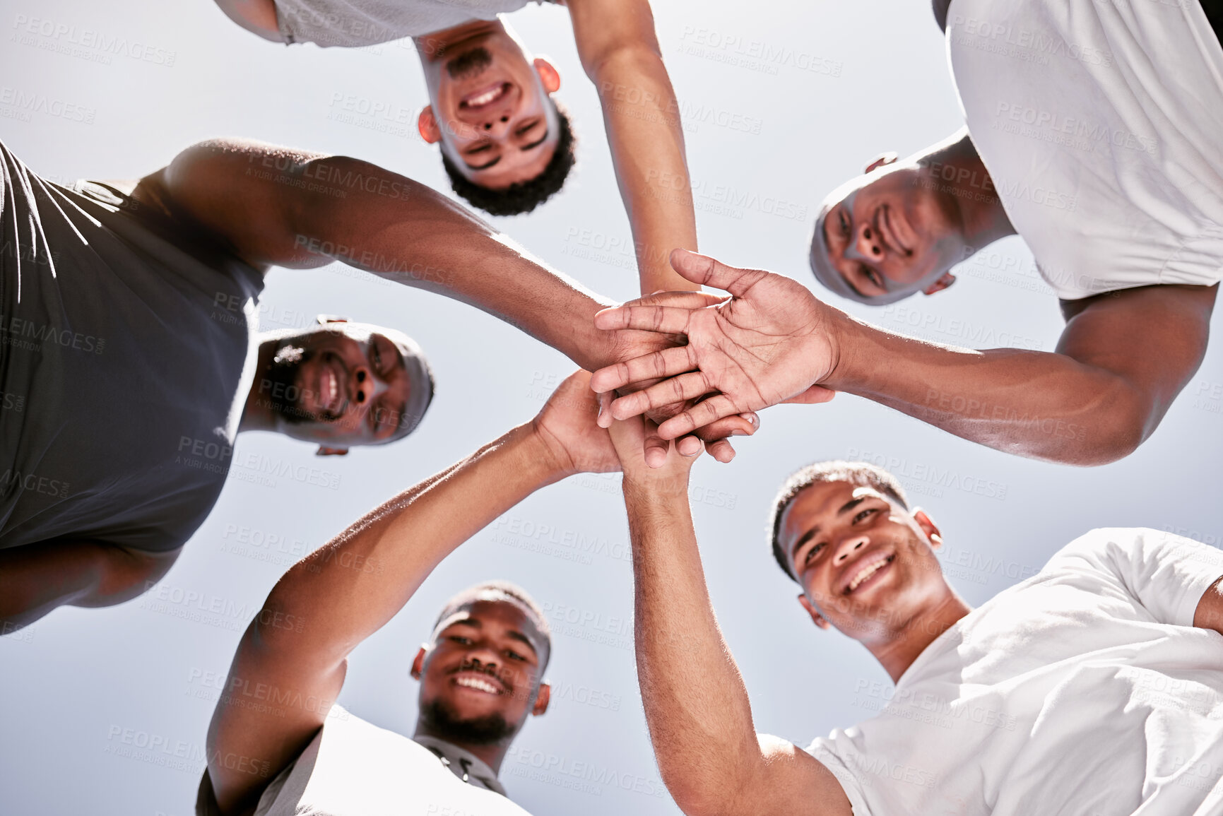 Buy stock photo Portrait of sporty men stacking hands in a huddle for team support, collaboration and unity from below. Group of cheerful and motivated athletes joining together in a circle for  encouraging pep talk