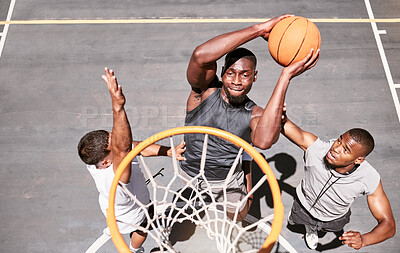 Buy stock photo Basketball players blocking a player from dunking a ball into net to score points during a match on sports court from above . Fit athletes jumping to defend in competitive game for recreational fun