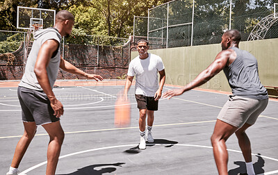 Three african american men playing basketball on a court outdoors. Black man and his sporty friends being athletic outside. Group of basketball players competing in a match or game for recreation fun