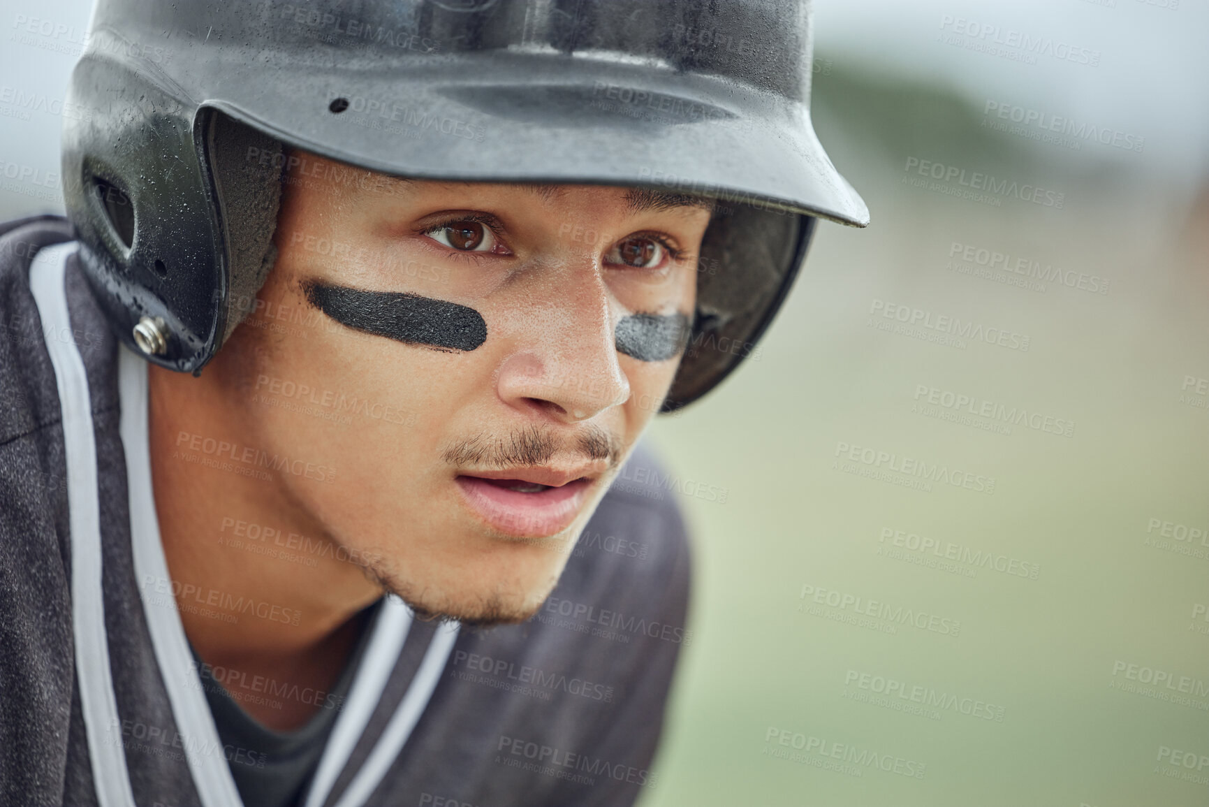 Buy stock photo Closeup of baseball player looking focused with warrior paint on his face. Zoomed in on serious fit, active athlete wearing a helmet during a game on a pitch. Headshot of sporty man playing a match