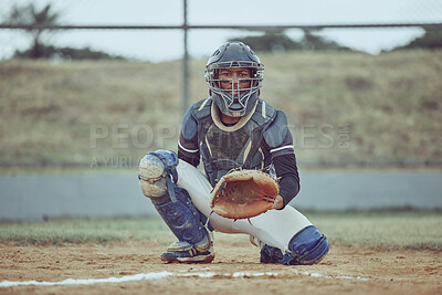 Portrait african american pitcher ready to make a catch with a mitt on a baseball field. Young sportsman in a helmet ready for the ball. Black man athlete playing a game or match on pitch outdoors