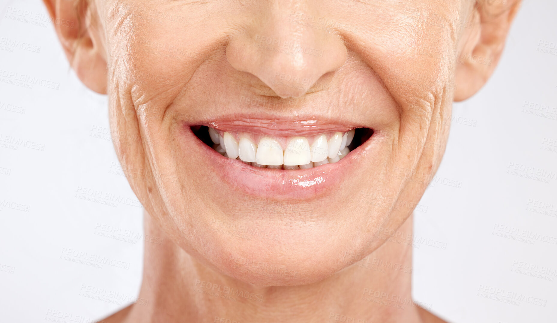 Buy stock photo Teeth, mouth and smile of a senior woman with dental cleaning against a grey studio background. Dentist, wellness and elderly model with healthcare and happy with results from veneers for beauty