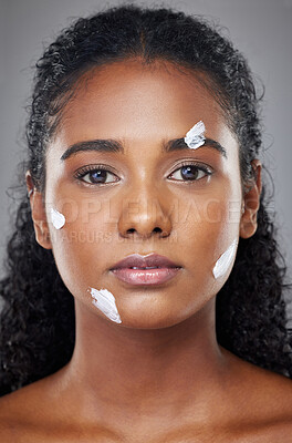 Buy stock photo Beauty, face and skincare cream with black woman in a studio for wellness, grooming and hygiene against grey background. Portrait, model and sunscreen product for cosmetic, dermatology and facial