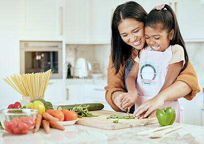 Buy stock photo Happy, mother and child learning to cook with smile for help, guidance and support in the kitchen. Mama helping her little girl cut vegetables, food or meal for healthy diet and fun bonding at home