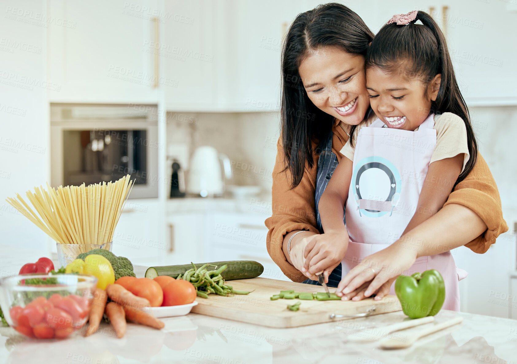Buy stock photo Happy, mother and child learning to cook with smile for help, guidance and support in the kitchen. Mama helping her little girl cut vegetables, food or meal for healthy diet and fun bonding at home