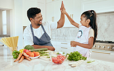 Buy stock photo Food, family and high five with girl and father in a kitchen preparing a meal, bonding and having fun in their home. Love, kids and parent help, trust and support while cooking a balanced dinner