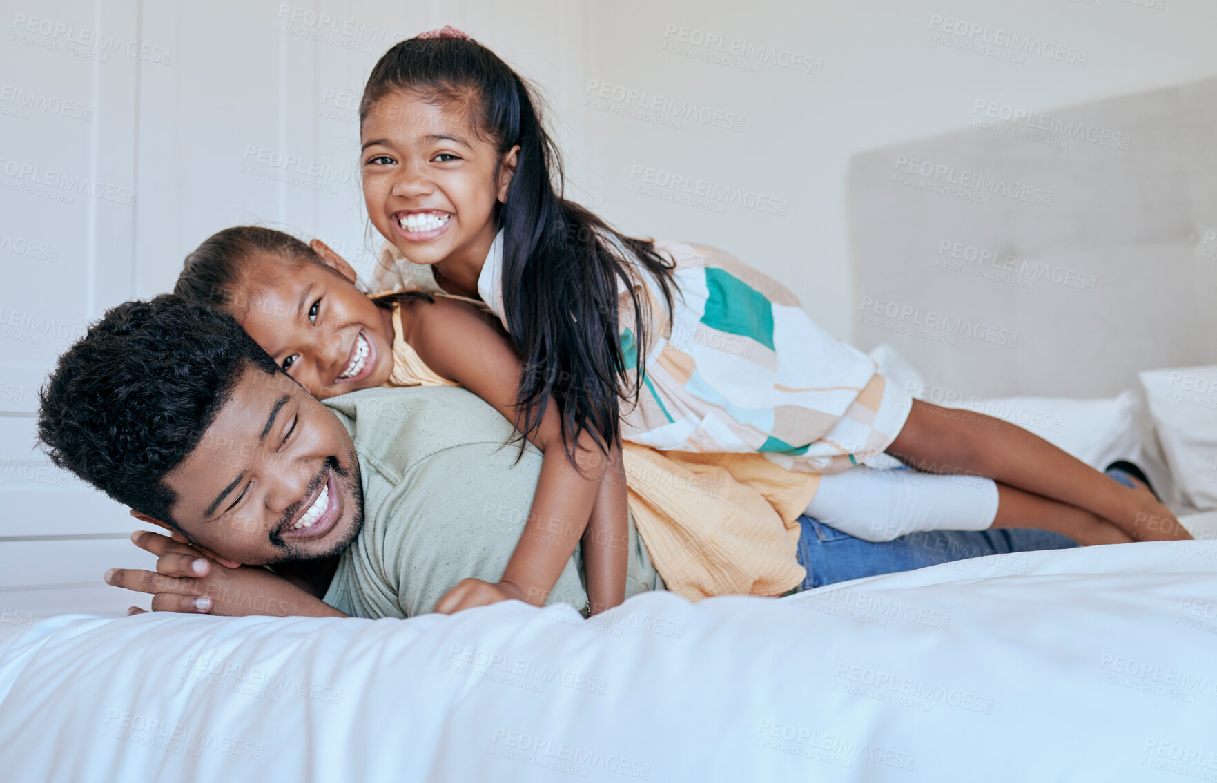Buy stock photo Happy family, dad and girl kids on bed in home with smile, portrait father and children play together in Asia. Love, fun and family time for dad and daughters in bedroom in family home  in Indonesia