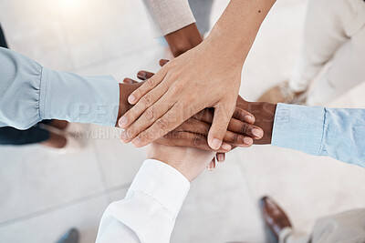 Buy stock photo Hands, teamwork and motivation with business people standing in a huddle or circle together from above. Office, meeting and solidarity with a man and woman employee group joined in unity or trust