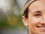 Face, eye and mockup with a young woman outdoor next to a bokeh background for marketing or advertising. Happy, smile and product placement with an attractive female posing beside empty space