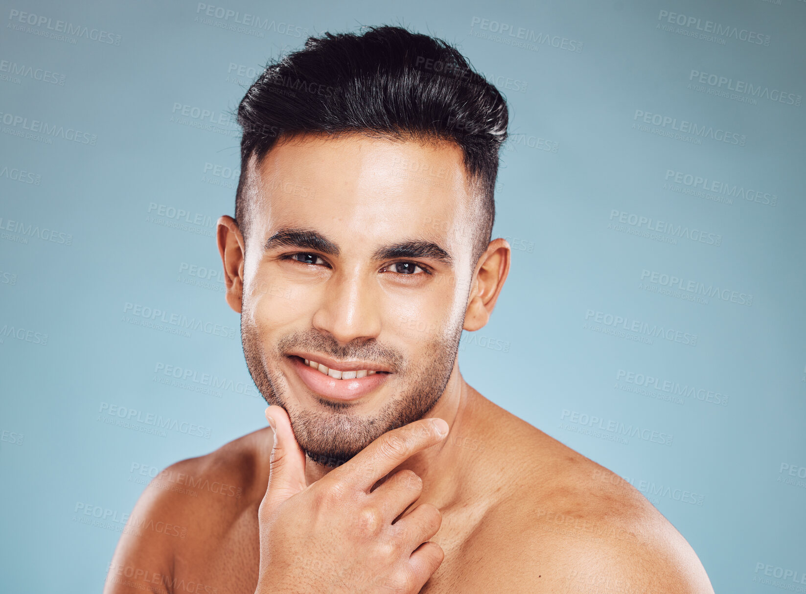 Buy stock photo Portrait, Indian man and skincare for wellness, smile and happy with blue studio background. Male, confident or natural beauty for cosmetics, luxury or happiness for organic facial or pride with fun