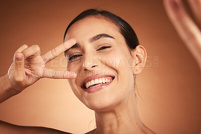 Buy stock photo Face, peace sign and woman happiness selfie of a model with a funny hand sign. Portrait of a comic hand gesture and beauty laughing, feeling silly and happy about youth with smile and beautiful skin
