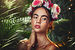 Flowers, nature and beauty of a model in a forest with natural skincare, makeup and skin wellness. Woman with a flower crown in a forest or jungle with organic skin care and natural cosmetics  