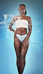 water splash, woman and skincare health for wellness or beauty cleaning lifestyle. Young African model, rich healthy skin tone and natural cosmetic body glow with water in blue background studio