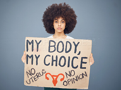 Buy stock photo Black woman afro, protest and poster for abortion, female choice or decision against a studio background. Portrait of African American female taking a stand holding cardboard sign for empowerment