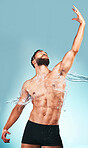 Muscular man, water splash and shower for skincare, clean and beauty with marketing OR advertising for luxury product. Model posing with body cleaning, skin and hygiene in studio mockup background