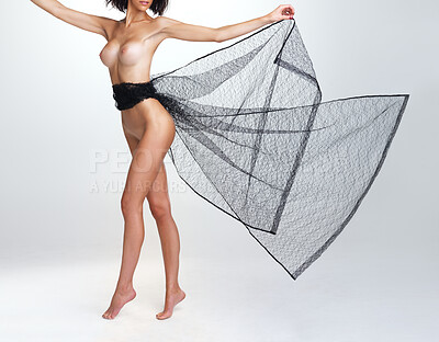 Buy stock photo Beautiful nude woman with a net draped around her moving gracefully while isolated on grey