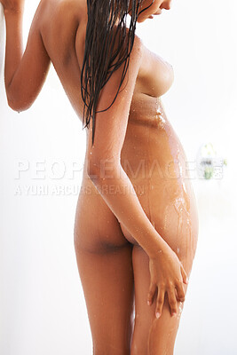 Buy stock photo Rearview shot of an attractive naked woman taking a shower