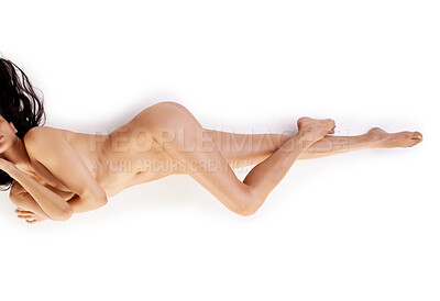 Buy stock photo Studio shot of a gorgeous naked woman lying seductively against a white background