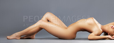 Buy stock photo Nude shot of an attractive young woman standing in the studio