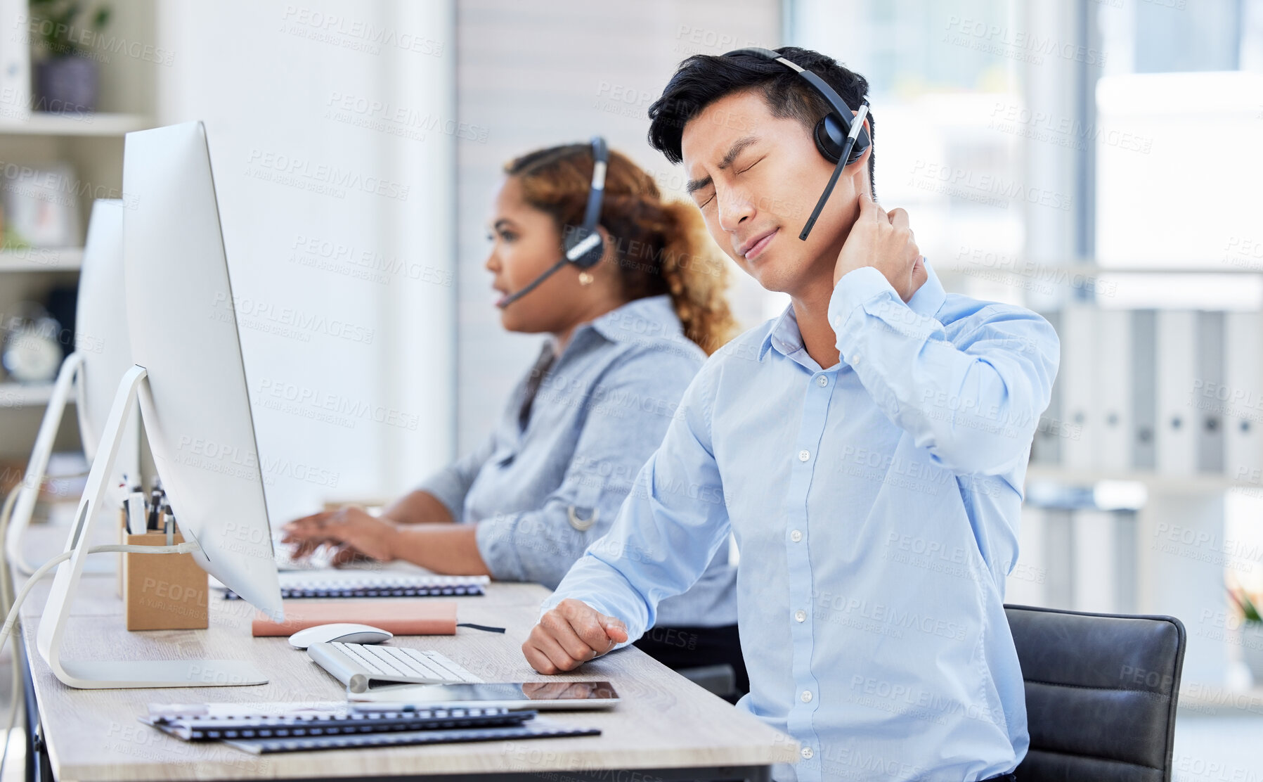 Buy stock photo Call center agent with neck pain, stress and sore back stretching bad, strained muscle at a modern office. Stressed ecommerce support sales consultant working overtime or sitting long hours at a desk