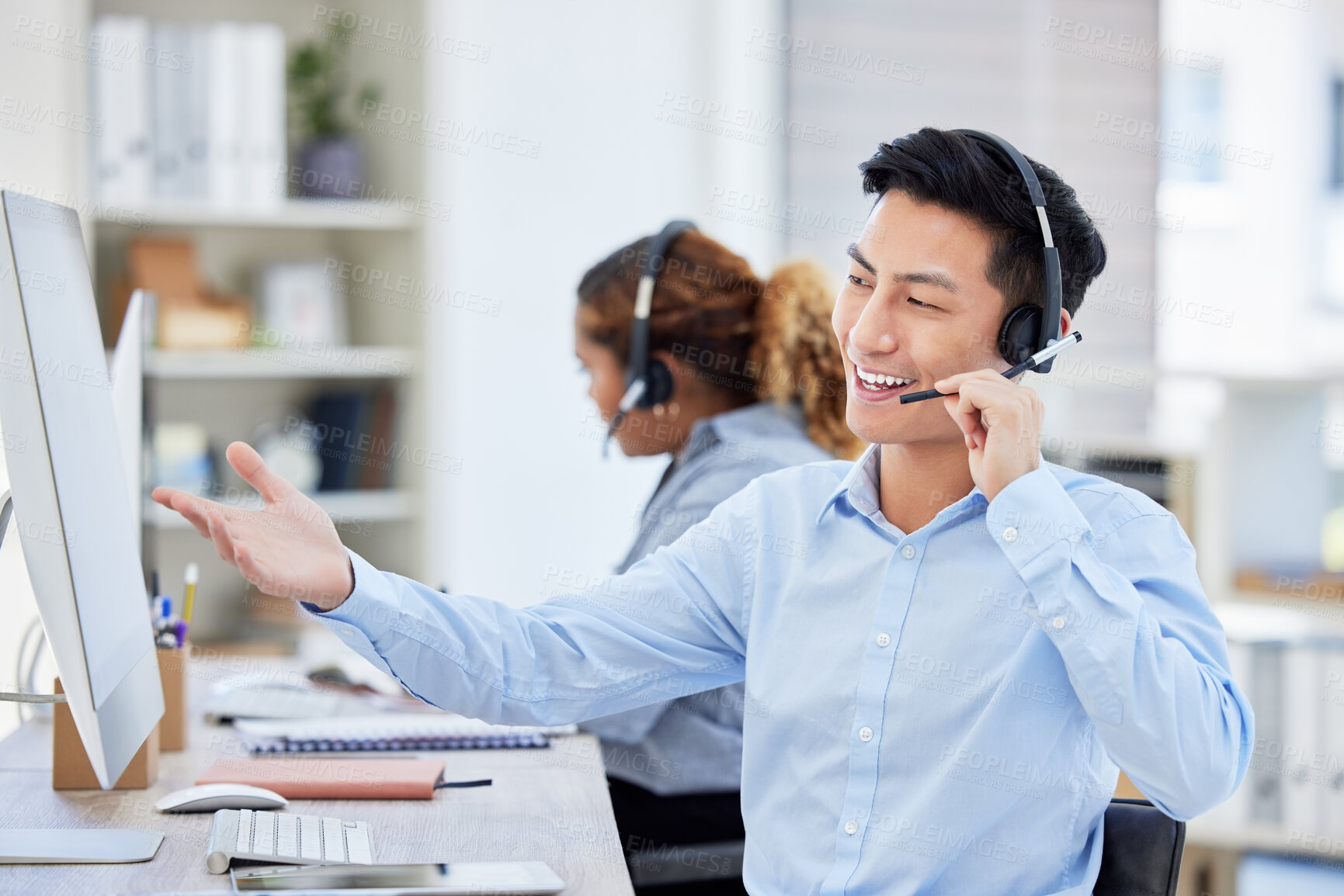 Buy stock photo Happy, confident and helpful call centre agent talking on a headset while working on computer in an office. Salesman or consultant operating a help desk for customer care and service support