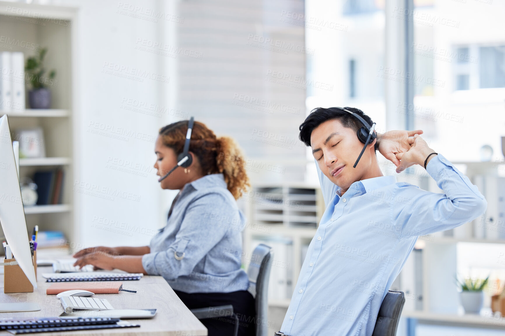 Buy stock photo Stretching, stressed and tired call centre agent suffering from burnout, backache or being overworked. Lazy, bored and exhausted customer service representative feeling sleepy and listening to client