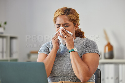 Buy stock photo Sick, ill, or unwell business woman suffering with a cold, flu or sinus infection and sneezing or blowing her nose with a tissue. Young female remote working on her laptop from the home office