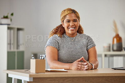 Buy stock photo Confident, happy and professional business woman looking  ready for success at her desk in the office. Young female sitting at work, smiling and feeling positive about her career goals