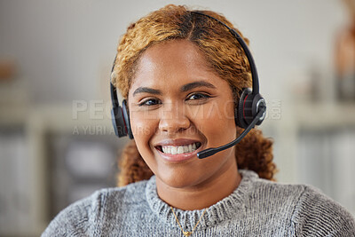 Friendly female call center agent smiling and happy to help in her office at work. Portrait of a young woman customer service employee looking excited and glad to support sitting at her workplace