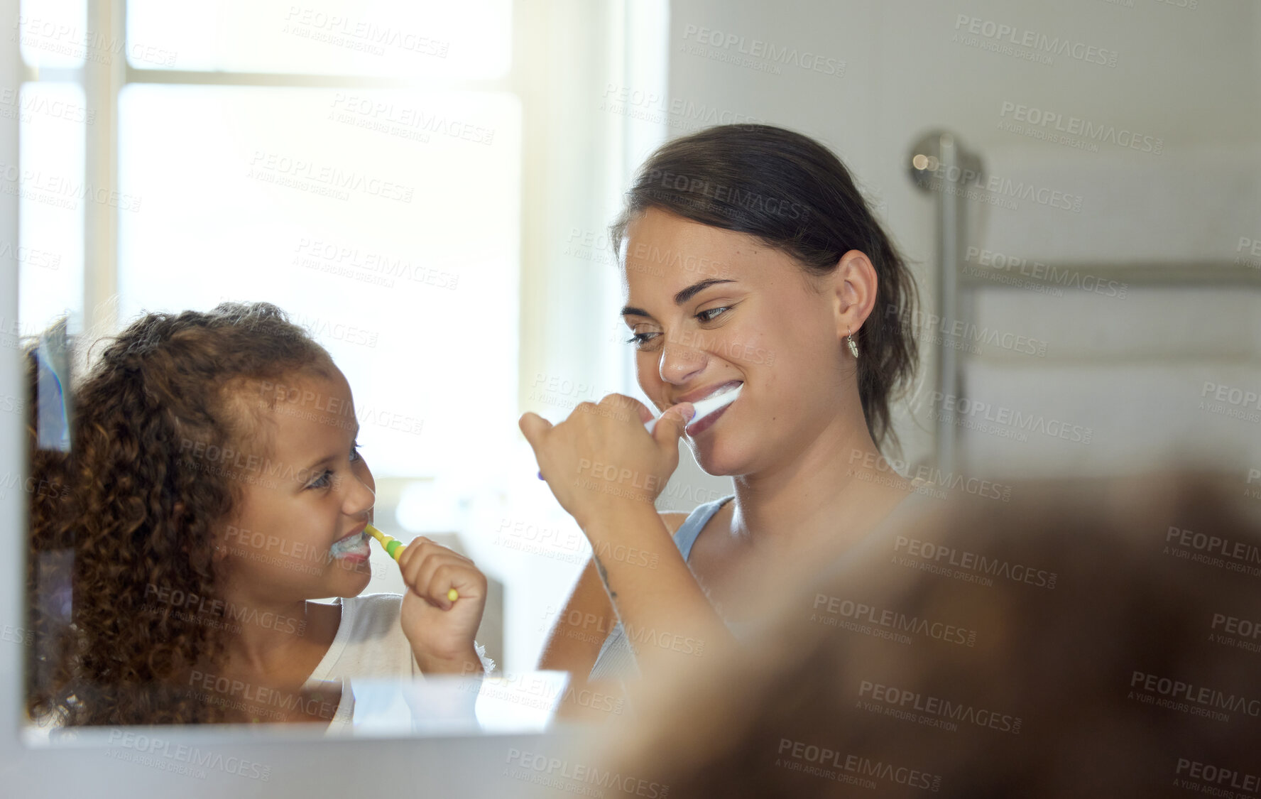 Buy stock photo Dental care, brushing teeth and healthy routine in mother and daughter morning at home. Happy, fun and playful child and parent bonding and learning hygiene and grooming with toothpaste in a bathroom