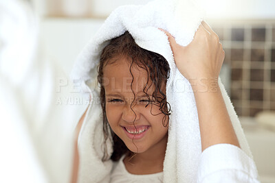 Buy stock photo Haircare routine, cleaning and hair being washed by a mother for her happy, carefree and smiling daughter at home. Loving, caring and kind parent helping her child get dressed, get dry or get clean