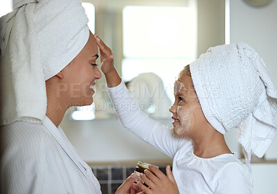Skincare, family and spa day for mother and daughter having a pamper session while bonding at home. Mom and child enjoying a facial and having fun together. Parent and girl doing a beauty cleanse