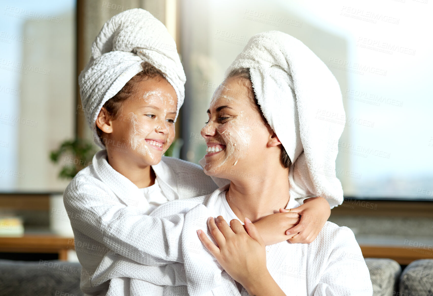 Buy stock photo Happy, smiling and relaxed mother and daughter spa day at home with face masks for healthy skincare and personal hygiene. Cute little girl and parent bonding and enjoying a pamper treatment together