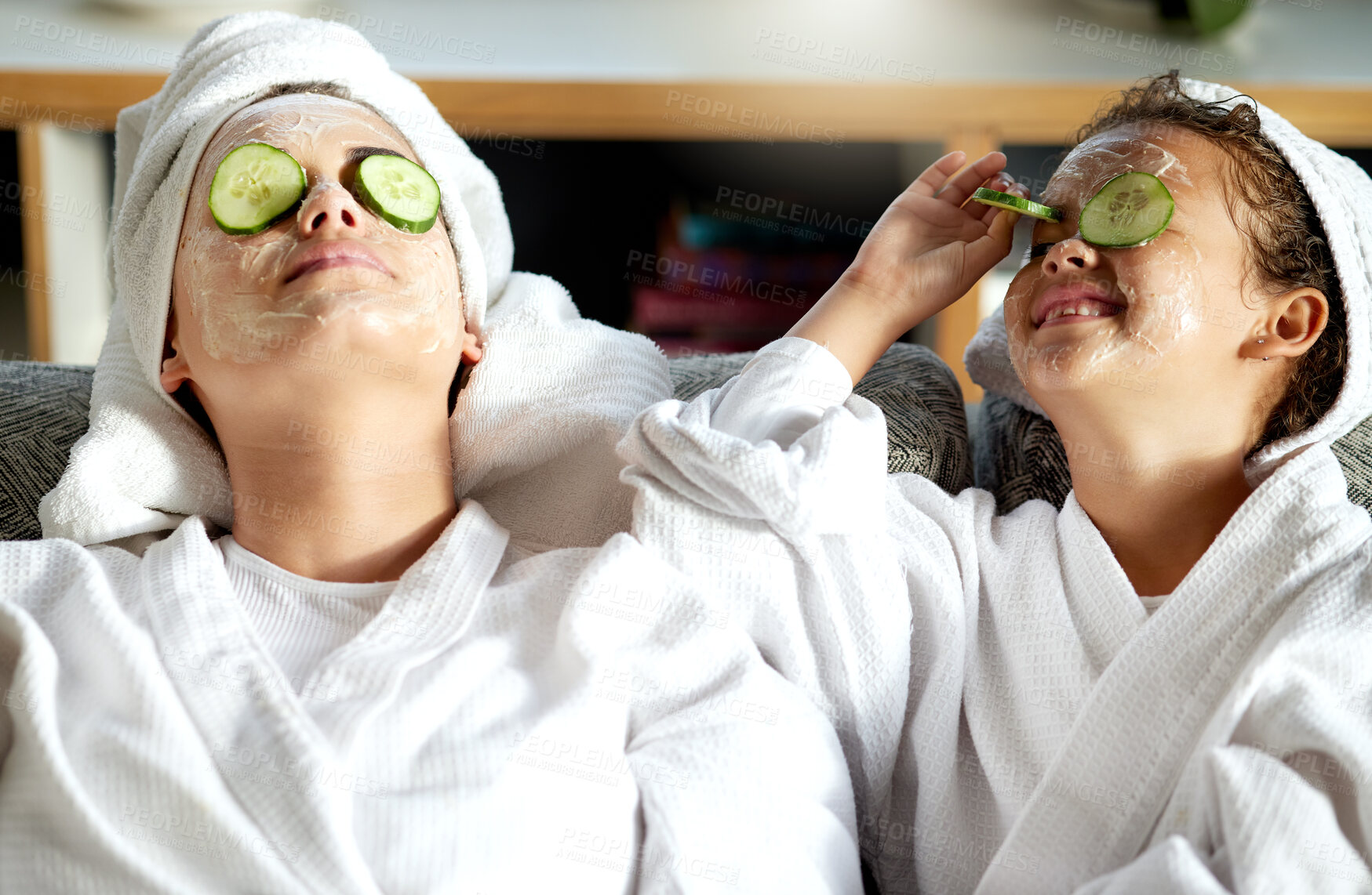 Buy stock photo Happy, carefree and relaxed mother and daughter having a relaxing spa day together. Cheerful, smiling and joyful little girl enjoying a pamper session on the weekend with her mom, nanny or babysitter