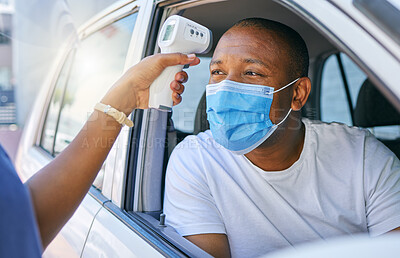 Buy stock photo Covid, corona and infection testing site as a drive thru service station for people traveling. African man wearing a protective face mask to avoid infection and stop the spread while driving his car
