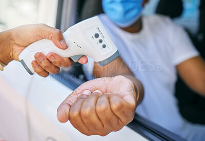 Buy stock photo Covid, corona infection testing and scan site as a drive thru service station for people traveling. African man having his temperature taken with a thermometer before entering an airport or workplace