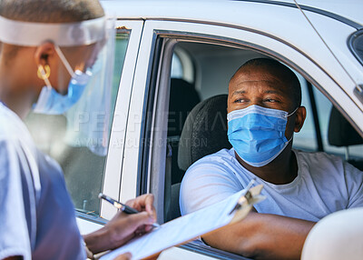 Buy stock photo Test, questions and screening at a covid drive thru checkpoint. A man traveling in a car talking to a healthcare professional writing his coronavirus details while wearing a face mask