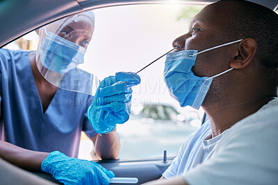 Doctor or nurse doing a drive thru covid or corona virus test on a black man sitting in a car. Medical professional taking nose swab sample from male patient through window with a PCR diagnostic kit.