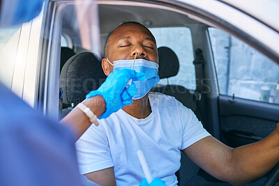 Buy stock photo Covid testing and screening of a man driving in his car at a drive through station with medical nurse assistance. Guy getting virus treatment test while wearing a protective face mask