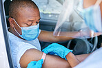Drive thru covid vaccine service outdoors for a patient driving in a car. A healthcare professional putting a plaster on a man in a vehicle after coronavirus treatment at a vaccination station