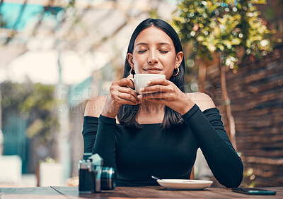 Beautiful, happy and relaxed woman smelling fresh coffee and enjoying a morning in cafe. Calm, zen and content student drinking a warm, hot and comforting cup of beverage drink in relaxing restaurant