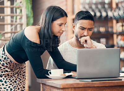 Buy stock photo Teamwork, cooperation and working together to solve a problem, software issues or computer failure. Female colleague helping male coworker while working and typing on a laptop inside a trendy cafe