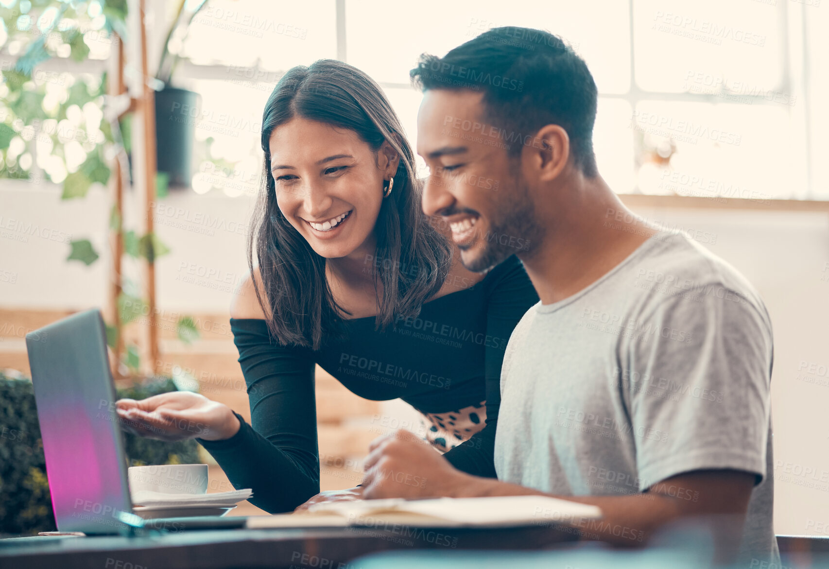 Buy stock photo Happy, smiling, cheerful entrepreneurs browsing the internet on a laptop inside a coffee shop. Two latino bloggers sharing ideas and laughing while posting online content inside a quiet restaurant