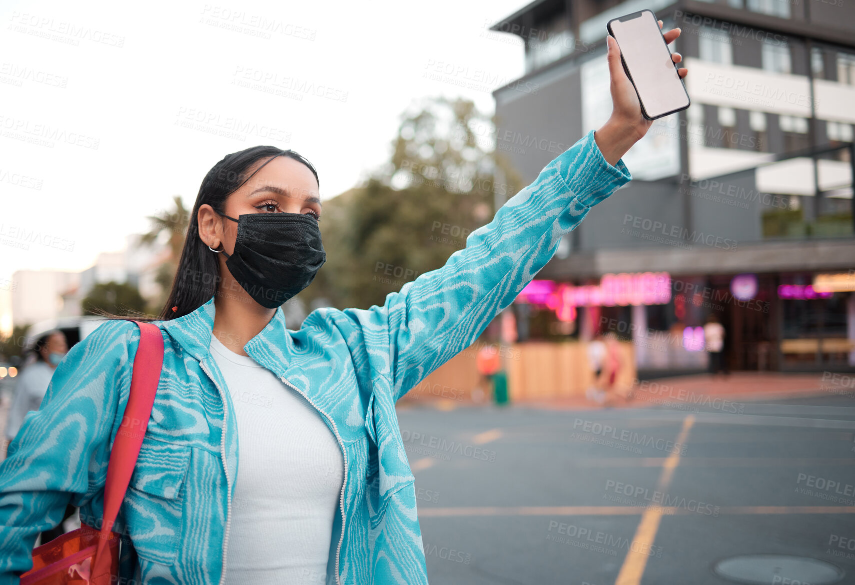 Buy stock photo Trendy, stylish and funky student with phone travel app wearing covid mask and hailing, or waving car, taxi and local transport or lift service. Cool, fashionable and careful woman in city
