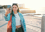 Fun, happy and trendy student taking a selfie on phone for social media while exploring, visiting and enjoying city. Beautiful, young and smiling tourist taking photos on technology while sightseeing