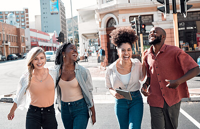 Buy stock photo Happy, young and free trendy friends having fun on a day in the city, laughing while walking and talking together. Diverse group exploring downtown, enjoying their free time on the weekend