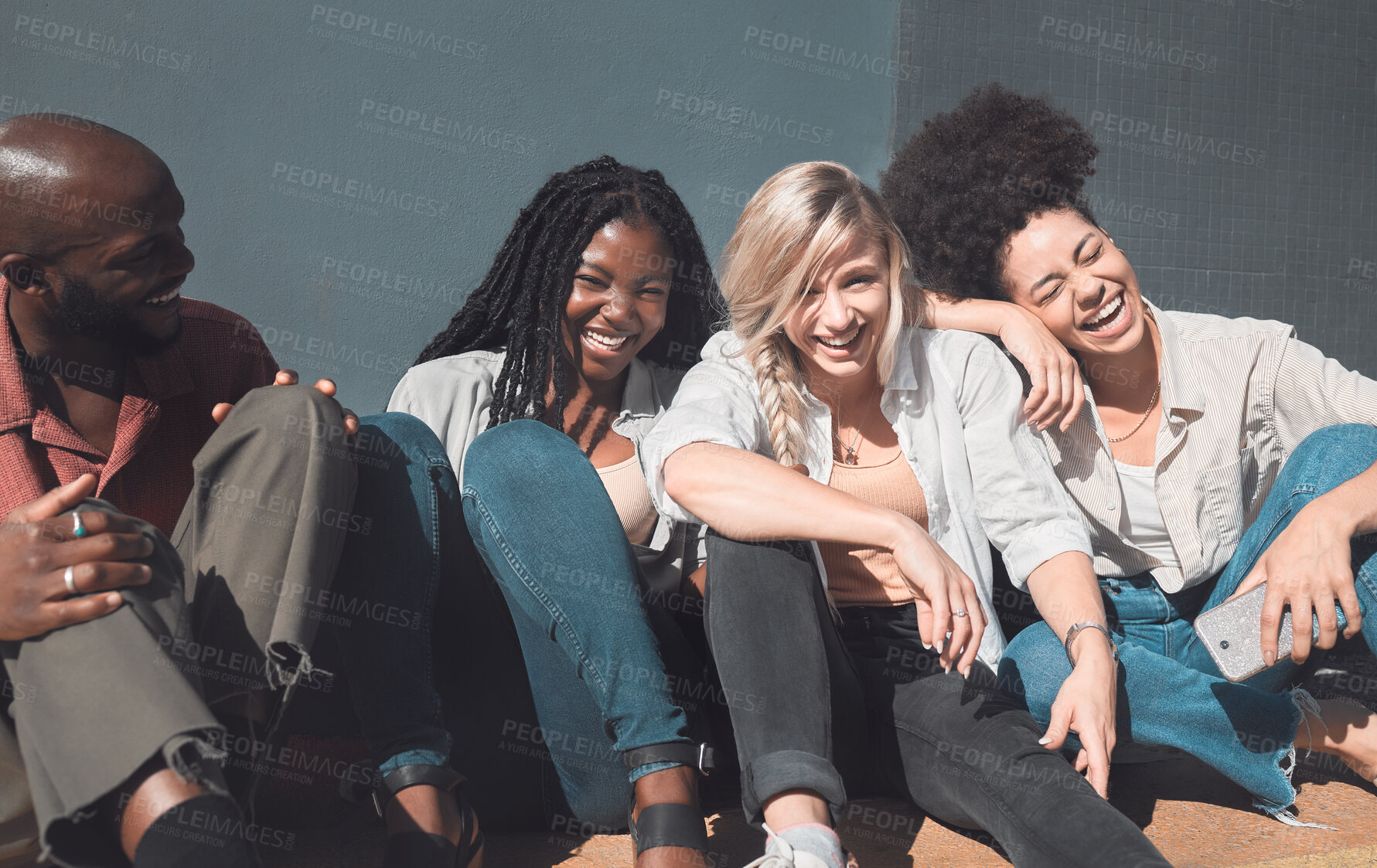 Buy stock photo Happy, trendy and carefree friends laughing, talking and having fun enjoying their free time together outside. Diverse group bonding, hangout out and relaxing while catching up on the weekend 