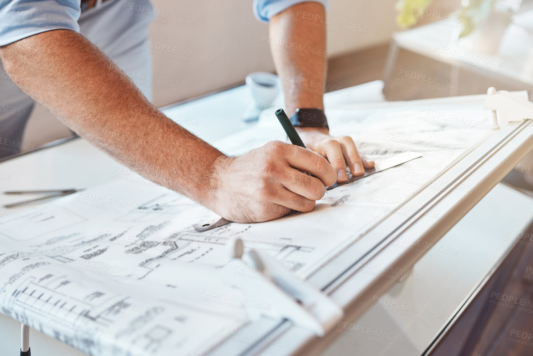 Buy stock photo Male architect hands drawing building project or construction plan on an office table. Closeup of caucasian man taking measurement notes, sketching and making corrections to a blueprint.