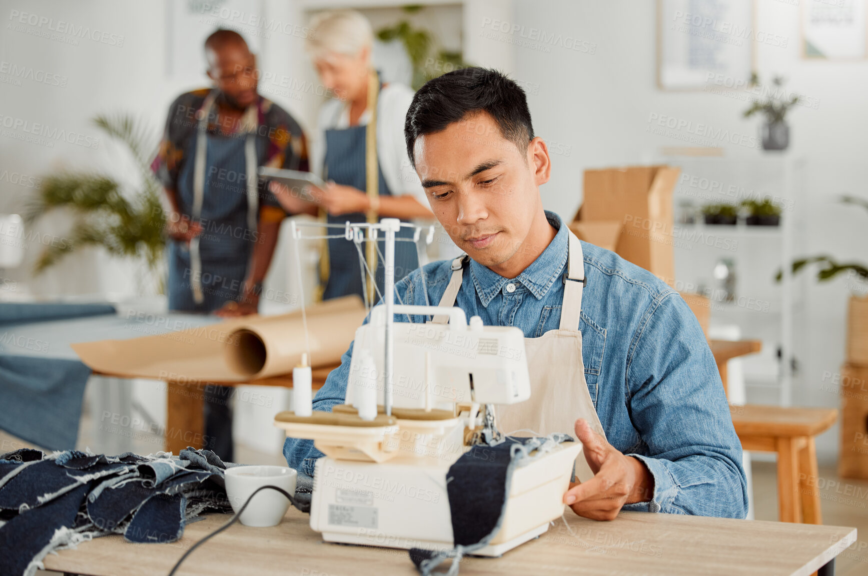 Buy stock photo Tailor stitching and making clothes with sewing machine in fashion, design and creative workshop. Serious man working on handmade, trendy and stylish clothing for fashionable boutique or store